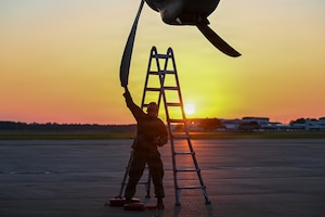 A maintainer from the 317th Aircraft Maintenance Squadron checks the props on a C-130J Super Hercules assigned to the 39th Airlift Squadron from Dyess Air Force Base, Texas, on May 13, 2026, at the Combat Readiness Training Center in Gulfport, Mississippi. Maintainers conducted around-the-clock operations to ensure aircraft were ready to meet the requirement outlined in the simulated air tasking order. (U.S. Air Force photo by Senior Airman Isabella Ortega)