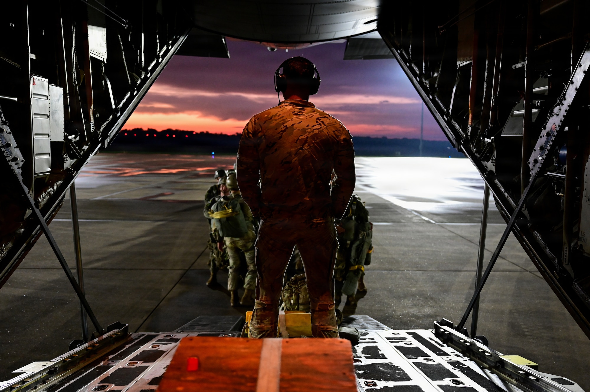 U.S. Air Force Tech. Sgt. Michael Gault, 39th Airlift Squadron loadmaster from Dyess Air Force Base, Texas, begins boarding Soldiers from the 1st Battalion 509 Infantry Regiment prior to a nighttime static-line airdrop operation on May 11, 2026, during STORM FLAG 26-07 in Gulfport, Mississippi. The exercise strengthened airborne proficiency and showcased the 39th AS’ ability to project rapid combat airlift anywhere in the world. (U.S. Air Force photo by Senior Airman Isabella Ortega)