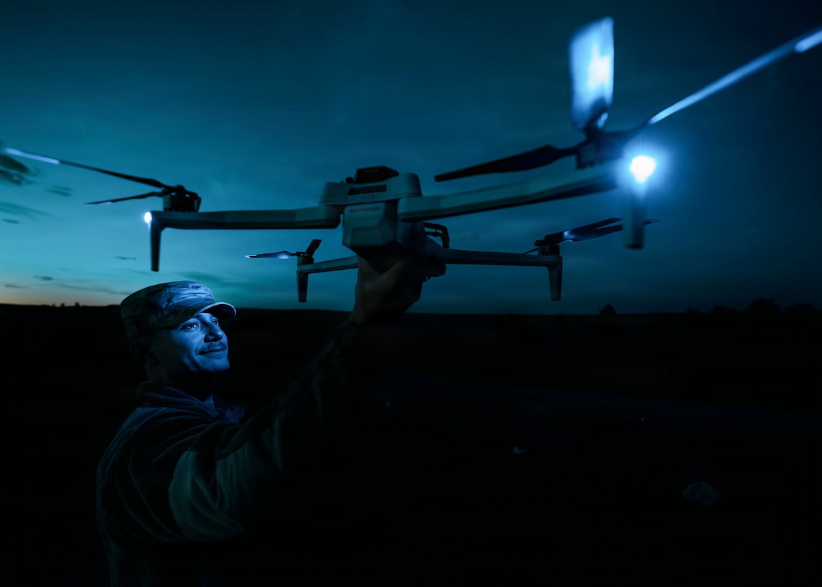 A 90th Missile Security Operations Squadron defender holds up a small unmanned aircraft system at Camp Guernsey Joint Training Center’s North Training Area, Wyo., April 7, 2026. The training enhanced defenders’ ability to employ the technology for reconnaissance, situational awareness and force protection in support of missile security and convoy operations. (U.S. Air Force photo by Staff Sgt. Michael A. Richmond)