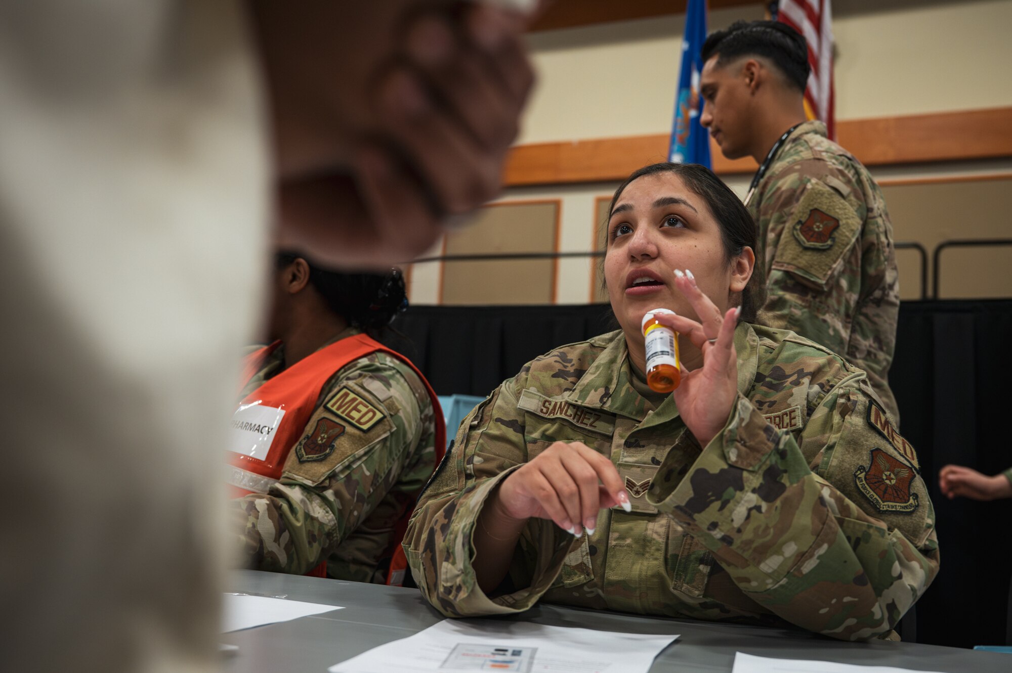A uniformed woman prescribed medication to a man.