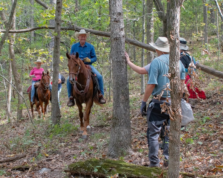 Hiker and horse riders on trail
