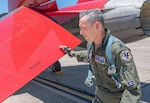 Lt. Col. Michael Trott, 99th Flying Training Squadron commander, conducts a pre-flight inspection on a T-7A Redhawk at Joint Base San Antonio-Randolph, Texas, May 14, 2026. Trott is one of the first two Air Education and Training Command pilots to be qualified on the new aircraft. This qualification is a critical milestone toward achieving Initial Operational Capability for the Air Force's newest advanced jet trainer.(U.S. Air Force photo by Benjamin Faske)