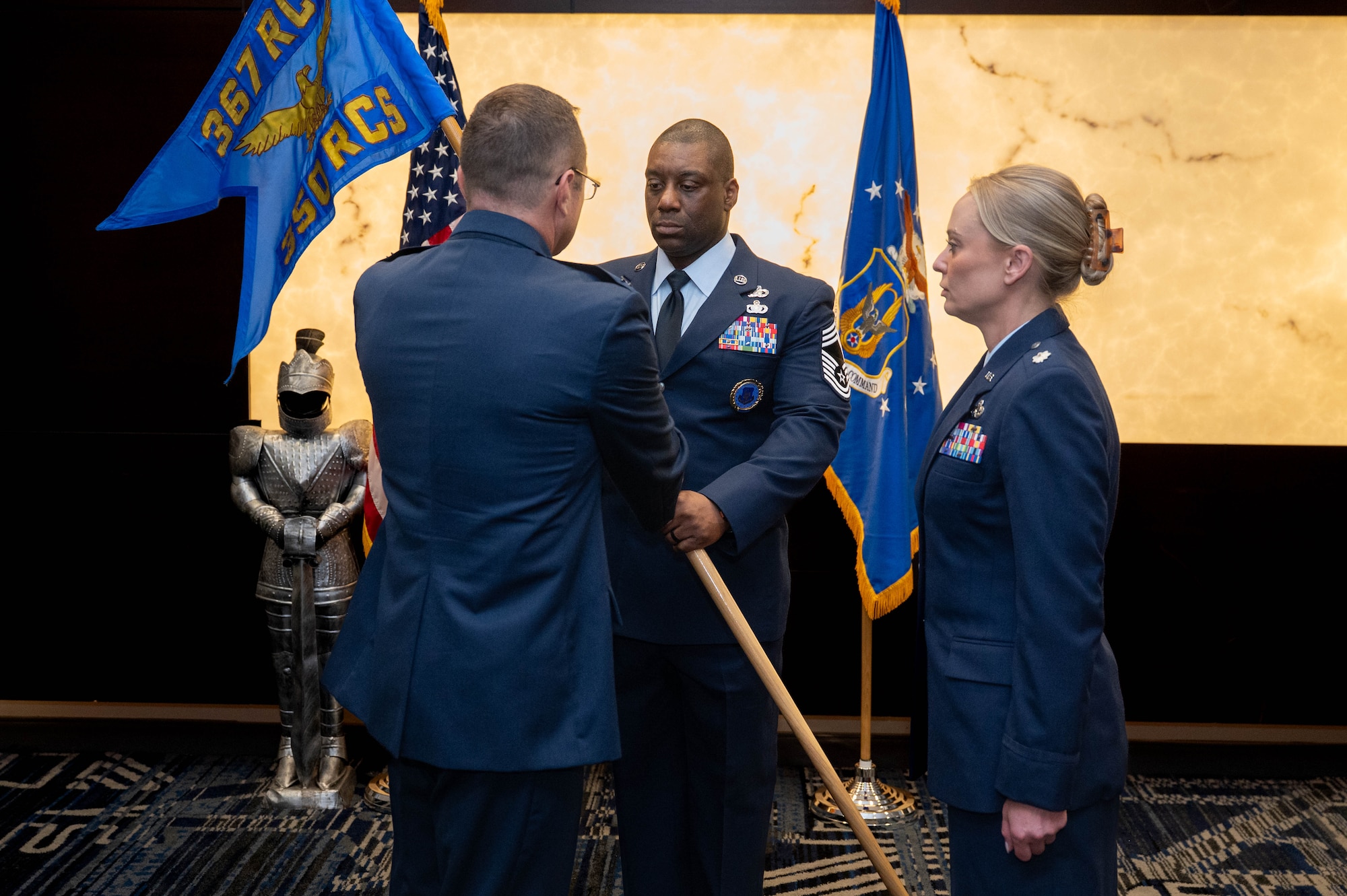 Chief Master Sgt. Armil Rucker, 350th Recruiting Squadron senior enlisted leader, Joint Base McGuire-Dix-Lakehurst, New Jersey, passes the guidon U.S. Air Force Col. Sean Fellows, 376th Recruiting Group commander, Robins Air Force Base, Georgia, before U. S. Air Force Lt. Col. Stephanie L. Bukowski, 350 RCS commander, Joint Base McGuire-Dix-Lakehurst, New Jersey, during the assumption of command ceremony, June 2, 2026, in Pittsburgh, Pennsylvania. An Assumption of Command is a formal military procedure where an incoming officer formally accepts the official authority, responsibility, and accountability of a unit. (U.S. Air Force photo by Master Sgt. Jeffrey Grossi)