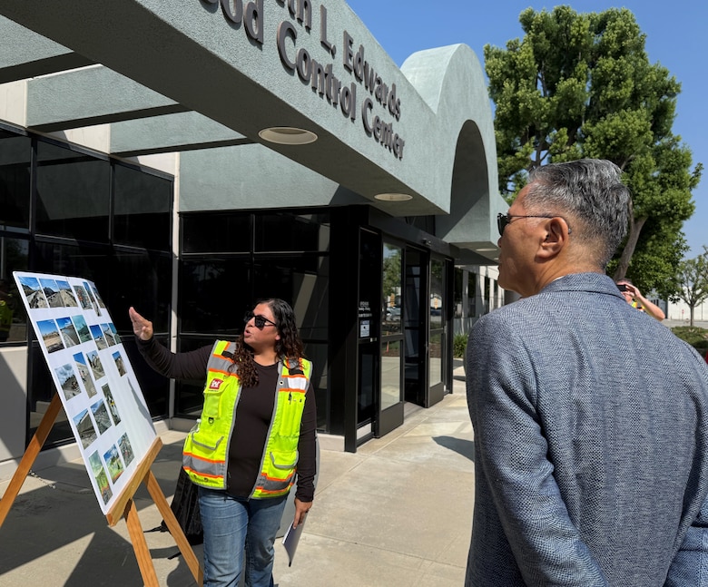 Adina Ortiz, construction representative with the U.S. Army Corps of Engineers Los Angeles District, left, briefs U.S. Rep. Mark Takano of California’s 39th Congressional District on the construction progress of the Riverside Levees Rehabilitation Project before a hard hat tour of the site May 8 in Riverside, California.