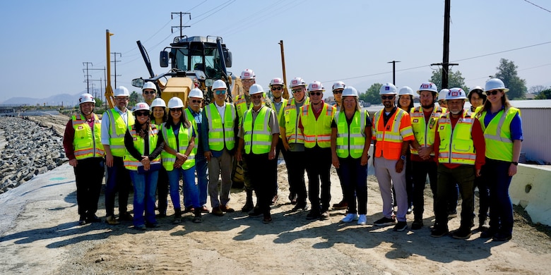 Partners and stakeholders gather May 8 for a group photo by the left levee in Riverside, California, which is now under construction is anticipated to be complete fall 2026.