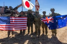 U.S. Marines with 1st Battalion, 5th Marine Regiment, Marine Rotational Force – Darwin 26, members of the Japanese Ground Self Defense Force, and Australian Army Soldiers with 1st Division pose for a photo after the opening ceremony of Exercise Southern Jackaroo in Townsville Field Training Area, Australia, May 29, 2026. Exercise Southern Jackaroo is a trilateral training event between the armed forces of Australia, Japan, and the United States that builds combined combat readiness and interoperability in the Indo-Pacific through joint operations and live-fire training. (U.S. Marine Corps photo by Sgt. Kyle Chan)