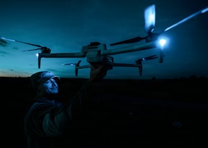 A 90th Missile Security Operations Squadron defender holds up a small unmanned aircraft system at Camp Guernsey Joint Training Center’s North Training Area, Wyo., April 7, 2026. The training enhanced defenders’ ability to employ the technology for reconnaissance, situational awareness and force protection in support of missile security and convoy operations. (U.S. Air Force photo by Staff Sgt. Michael A. Richmond)