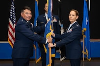 Air Force commander, passes the 37th Training Wing guidon to Col. Kellie S. Courtland, 37th TRW incoming commander, during the 37th TRW change of command ceremony at Joint Base San Antonio-Lackland, Texas, May 29, 2026. The change of command ceremony is a military tradition that allows unit members to see the outgoing commander depart and identify the incoming commander. (U.S. Air Force photo by Marcus Robins)