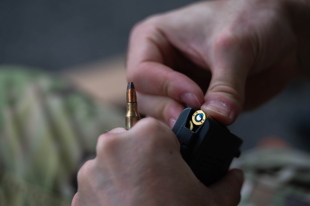 A U.S. Air Force Airman assigned to the 8th Security Forces Squadron loads a magazine before the defender weapon trainer class at a Republic of Korea Army shooting range, Republic of Korea, May 27, 2026. The defender weapon trainer course is a two-day course, pairing class-room instruction with live-fire qualification. (U.S. Air Force photo by Staff Sgt. Cedrique Oldaker)