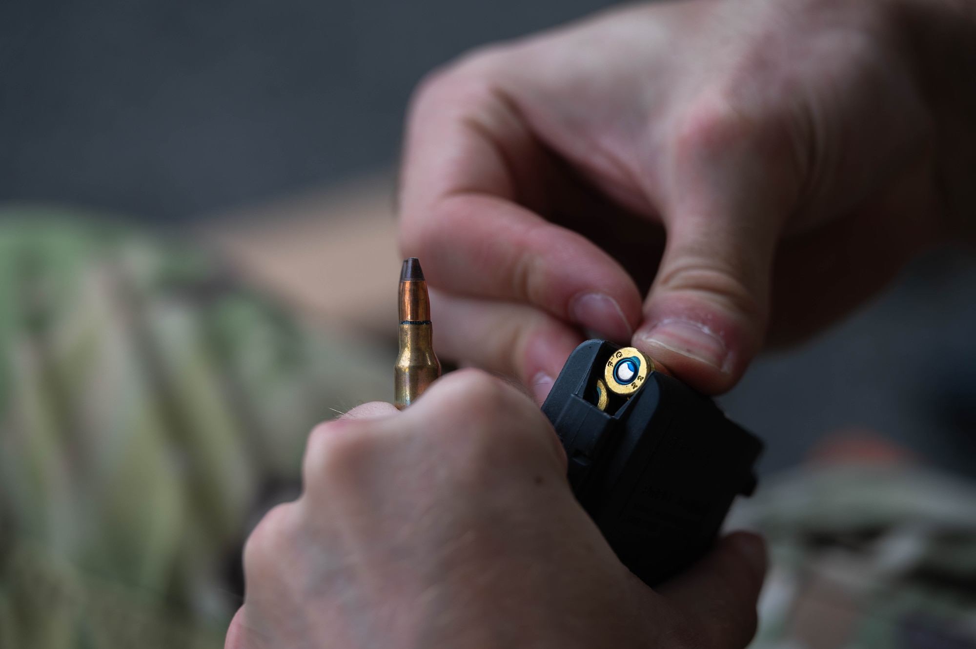 A U.S. Air Force Airman assigned to the 8th Security Forces Squadron loads a magazine before the defender weapon trainer class at a Republic of Korea Army shooting range, Republic of Korea, May 27, 2026. The defender weapon trainer course is a two-day course, pairing class-room instruction with live-fire qualification. (U.S. Air Force photo by Staff Sgt. Cedrique Oldaker)