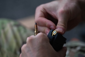 A U.S. Air Force Airman assigned to the 8th Security Forces Squadron loads a magazine before the defender weapon trainer class at a Republic of Korea Army shooting range, Republic of Korea, May 27, 2026. The defender weapon trainer course is a two-day course, pairing class-room instruction with live-fire qualification. (U.S. Air Force photo by Staff Sgt. Cedrique Oldaker)