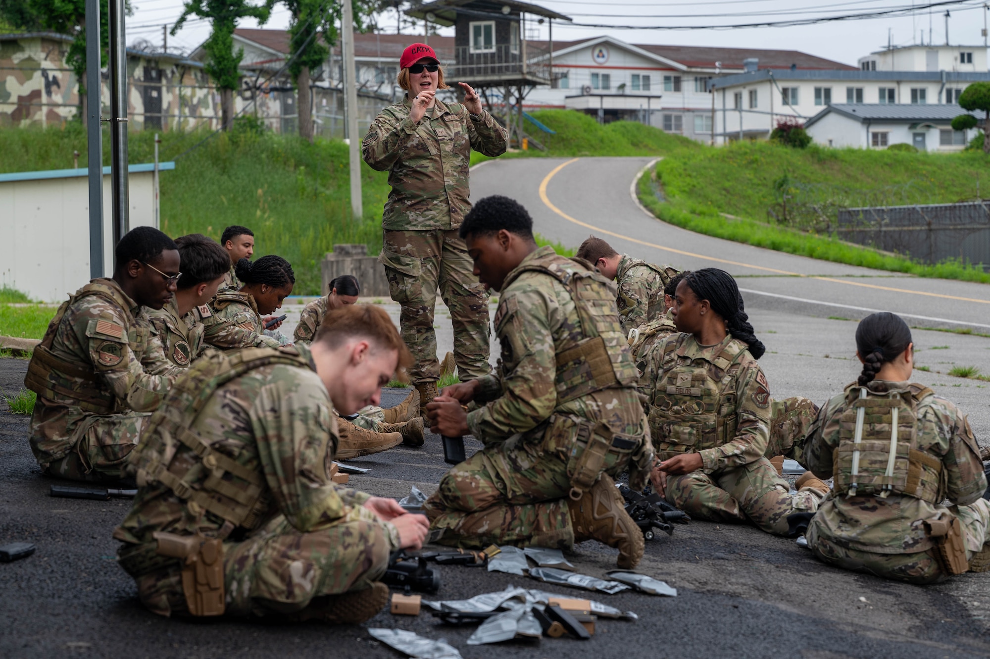 U.S. Air Force Staff Sgt. Lynn Cartagena, 8th Security Forces Squadron combat arms training and maintenance supervisor, instructs 8th SFS members on how much ammunition to prepare for training at a Republic of Korea Army shooting range, ROK, May 27, 2026. The course is designed to decentralize training authority, dispersing instructor capabilities across the entire squadron versus a specialized flight. (U.S. Air Force photo by Staff Sgt. Cedrique Oldaker)