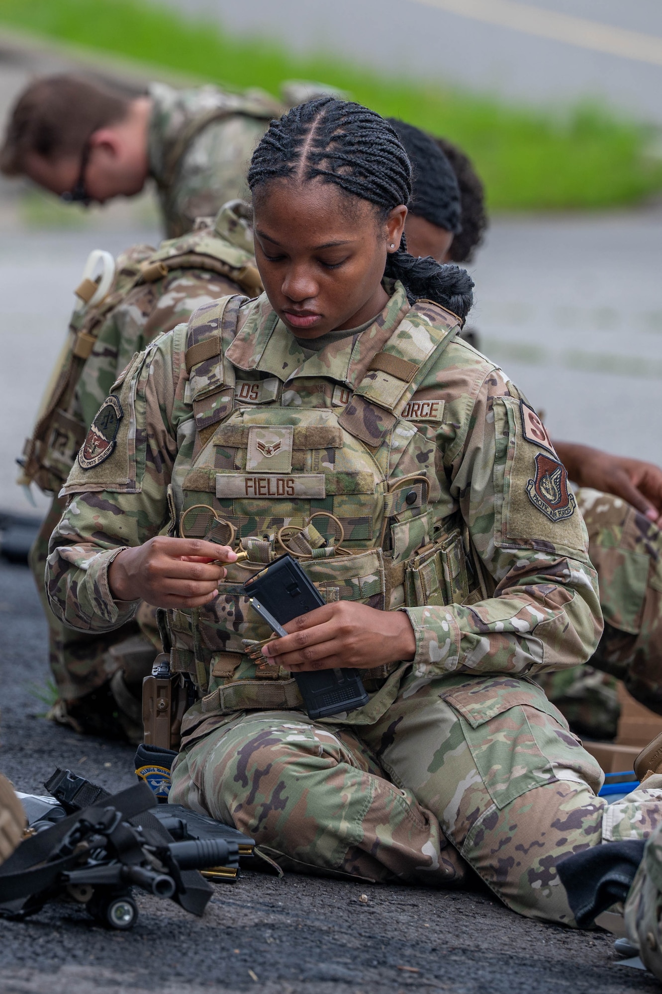 U.S. Airman 1st Class Caitlin Fields, 8th Security Forces Squadron alarm monitor, loads a magazine for the defender weapon trainer class at a Republic of Korea Army shooting range, ROK, May 27, 2026. This initiative marked the first time the unit utilized 8th SFS defenders, rather than combat arms specialists, as the primary instructors. (U.S. Air Force photo by Staff Sgt. Cedrique Oldaker)