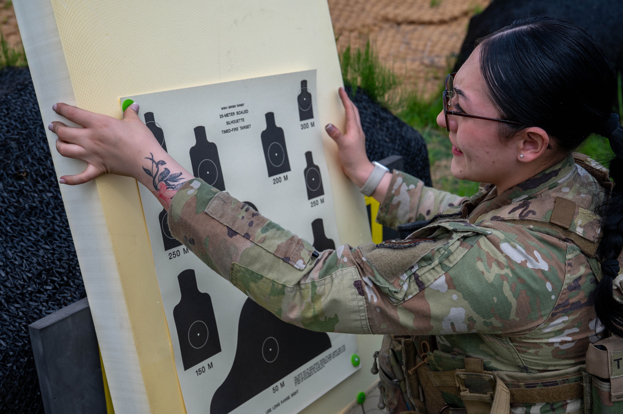 U.S. Air Force Airman 1st Class Mariana Contreras, an 8th Security Forces Squadron counter-small unmanned aerial system operator, pins a target during a defender weapon trainer class at a Republic of Korea Army shooting range, ROK, May 27, 2026. The training supported Kunsan’s inaugural defender weapon trainer course, which aims to integrate nonspecialized personnel into training roles. (U.S. Air Force photo by Staff Sgt. Cedrique Oldaker)