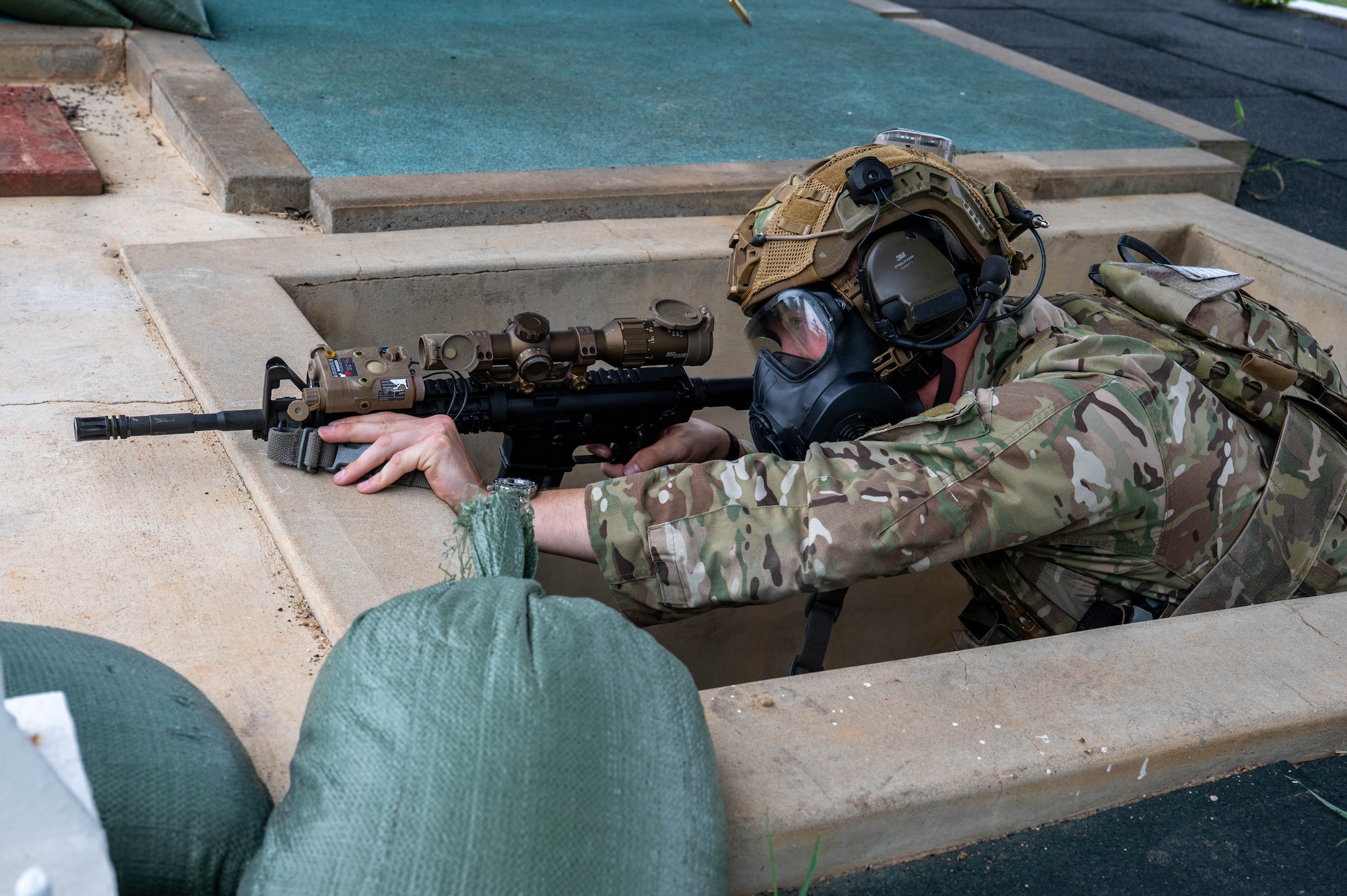U.S. Air Force 1st Lt. Bridger Boyd, 8th Security Forces Squadron flight commander, fires his rifle while wearing a gas mask during the defender weapon trainer course at Republic of Korea shooting range, ROK, May 27, 2026. The defender weapon trainer course is a two-day course, pairing class-room instruction with live-fire qualification. (U.S. Air Force photo by Staff Sgt. Cedrique Oldaker)