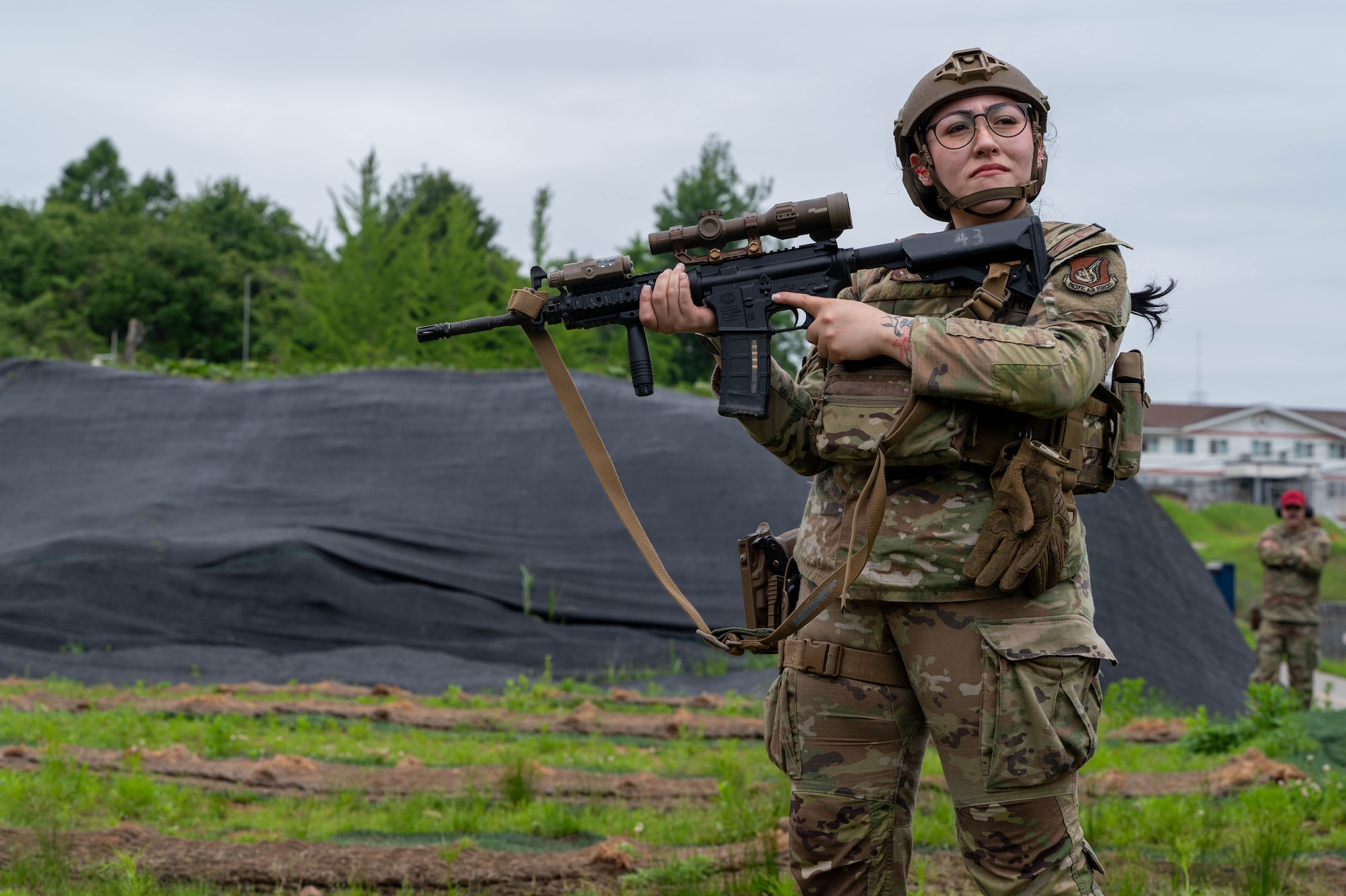 U.S. Airman 1st Class Mariana Contreras, 8th Security Forces Squadron counter small unmanned aerial system operator, prepares to fire during the defender weapon trainer course at a Republic of Korea shooting range, ROK, May 27, 2026. This initiative marked the first time the unit utilized 8th SFS defenders, rather than combat arms specialists, as the primary instructors. (U.S. Air Force photo by Staff Sgt. Cedrique Oldaker)