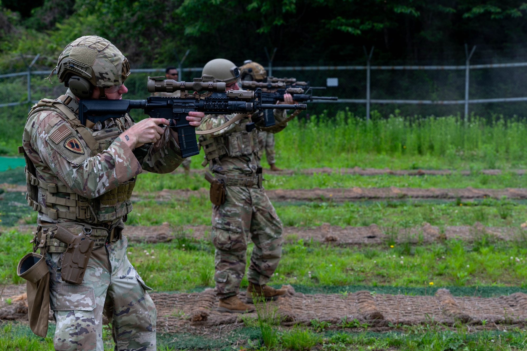 Members of the 8th Security Forces Squadron fire during the defender weapon trainer course at a Republic of Korea shooting range, ROK, May 27, 2026. The course is designed to decentralize training authority, dispersing instructor capabilities across the entire squadron rather than concentrating it solely within a specialized flight. (U.S. Air Force photo by Staff Sgt. Cedrique Oldaker)