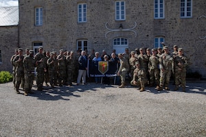 Big Red One Soldiers pose for a photo with the family of Paul Thomine, mayor of Colleville-sur-Mer, France, June 2, 2026. Pictured from left to right are Ret. U.S. Army Col. Paul Herbert, Laurence Thomine, daughter of Paulette Petit, a D-Day civilian survivor, and Bernard Petit, grandfather of Laurence Thomine. Paulette Petit survived the D-Day invasion as a child by sheltering inside her home while bullets struck the walls around her during the fighting in Normandy. (U.S. Army photo by Sgt. Joshua Fish)