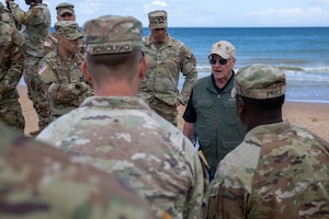Retired U.S. Army Col. Paul Herbert, former executive director of the First Division Museum at Cantigny Park, speaks to Soldiers assigned to the 1st Infantry Division on Omaha Beach in Normandy, France, June 2, 2026. Herbert spoke about the leadership, sacrifice and actions of 1st Infantry Division Soldiers during the D-Day invasion at Omaha Beach during World War II. (U.S. Army photo by Sgt. Joshua Fish)