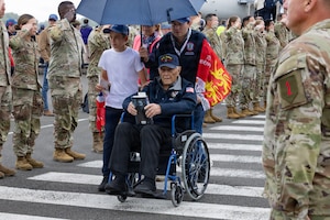 World War II veterans and guests sing the United States national anthem during an arrival event at the Deauville-Normandy Airport in Normandy, France, June 3, 2026. Veterans traveled to Normandy to participate in commemorative events honoring the 82nd anniversary of D-Day. (U.S. Army photo by Sgt. 1st Class Christopher Osburn)
