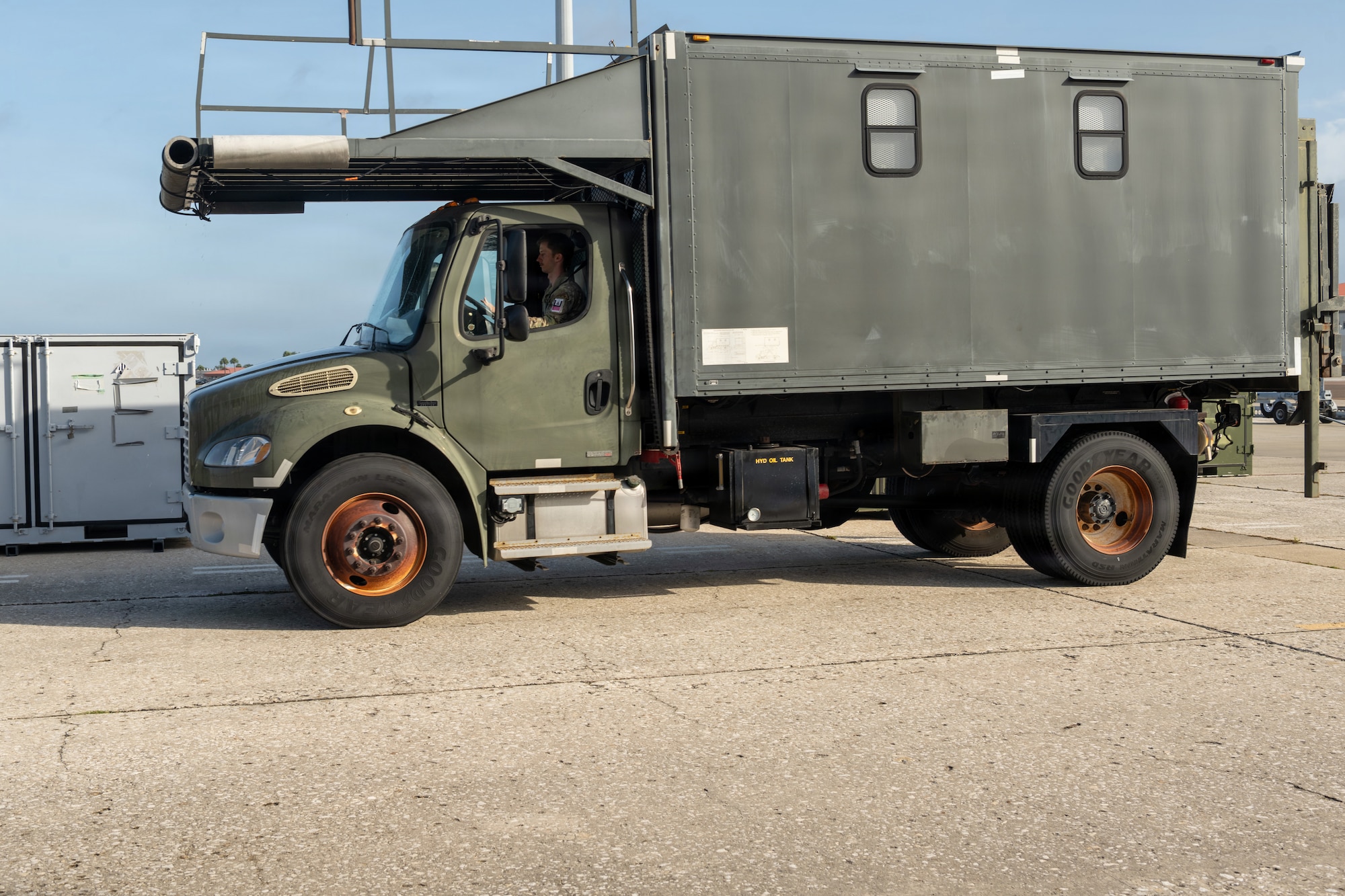 U.S. Air Force Senior Airman Caleb Johnson, 6th Operation Support Squadron, aircrew flight equipment apprentice, drives a high lift truck at MacDill Air Force Base, Florida, May 19, 2026. High lift trucks are specialized, hydraulically elevated vehicles used to load and unload heavy cargo, baggage and pallets directly into the elevated cargo doors of aircraft. (U.S. Air Force photo by Airman Micquill Davis)