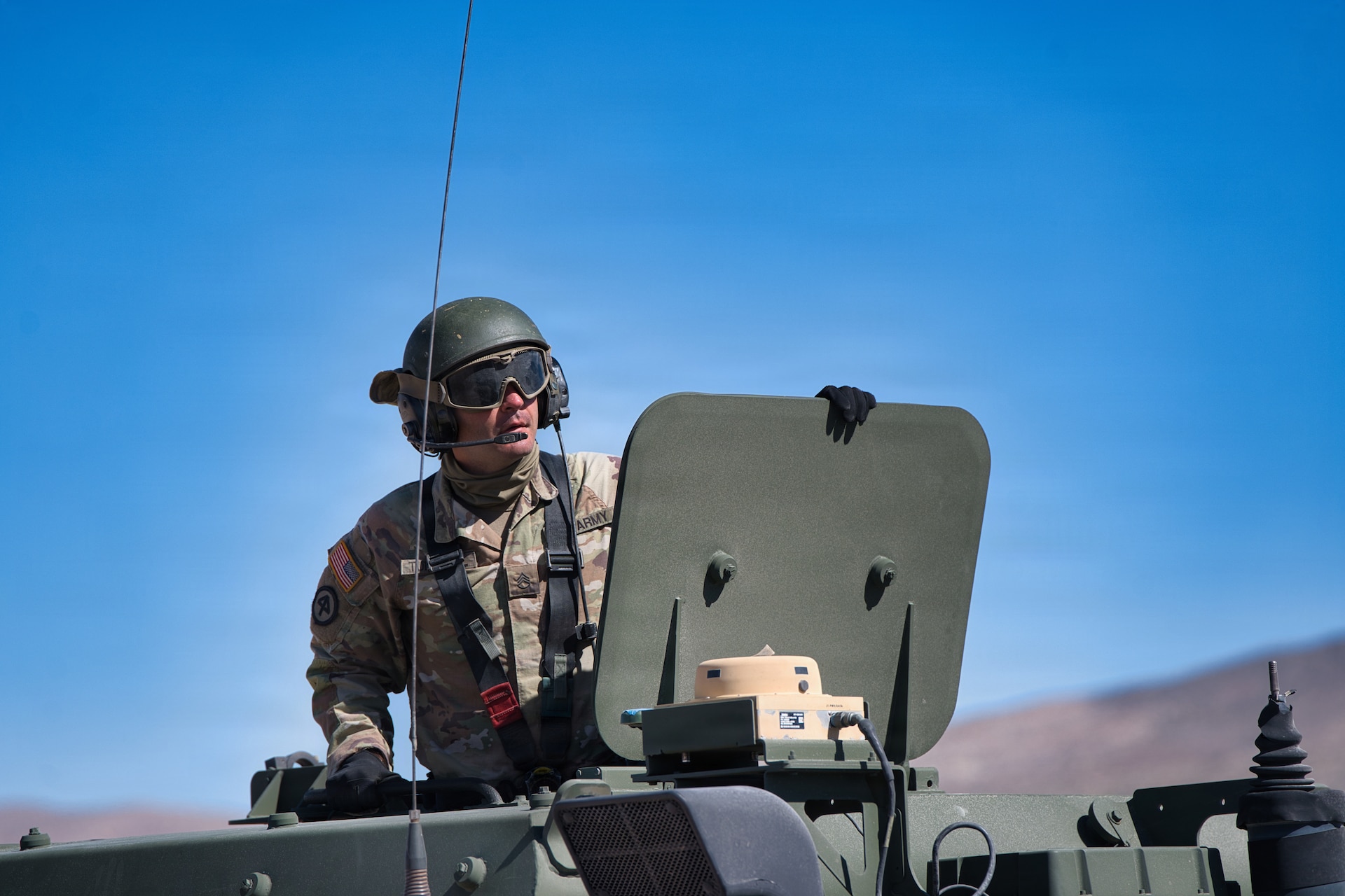 U.S. Army Staff Sgt. Zakari Turnbull looks beyond the hatch of a High Mobility Artillery Rocket System (HIMARS) during Exercise Arcane Thunder 26 at Fort Irwin, California, April 24, 2026.