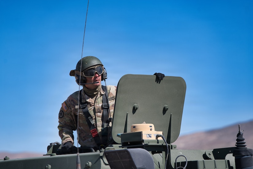 U.S. Army Staff Sgt. Zakari Turnbull looks beyond the hatch of a High Mobility Artillery Rocket System (HIMARS) during Exercise Arcane Thunder 26 at Fort Irwin, California, April 24, 2026.