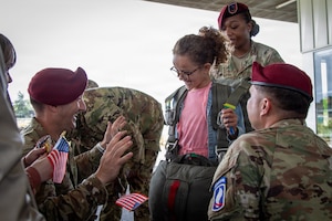 U.S. Army 1st Lt. Jeremy Shepler, left, a logistics officer assigned to the Light Support Battalion, 173rd Airborne Brigade, assists a student from Picauville Elementary School with a parachute harness during a D-Day 82 exchange at Picauville, France, June 2, 2026. The 173rd Airborne Brigade joined representatives from the Golden Knights and the Round Canopy Parachute Team to orient French school children to paratrooper equipment. (U.S. Army photo by Maj. Joe Legros)