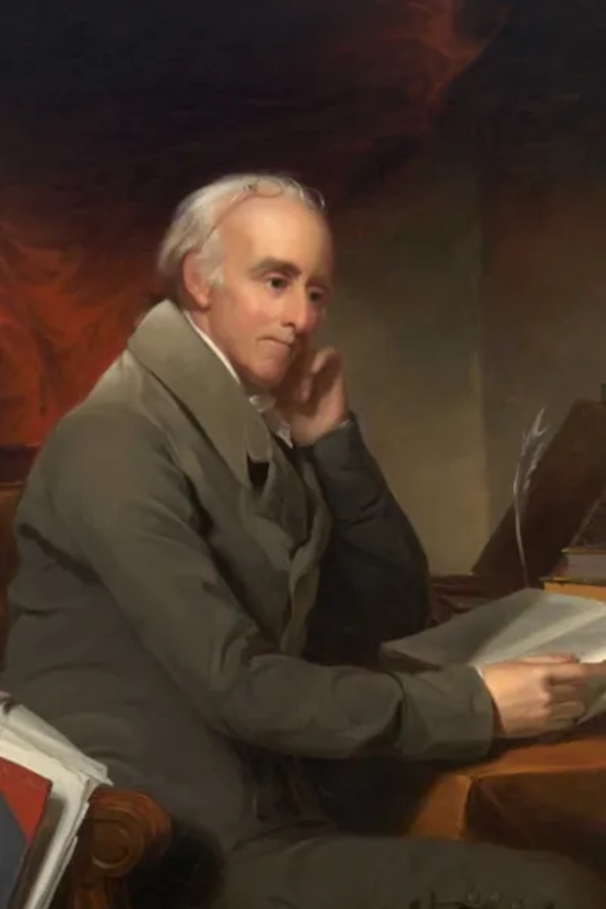 A painting of a man wearing colonial attire looking at a document.