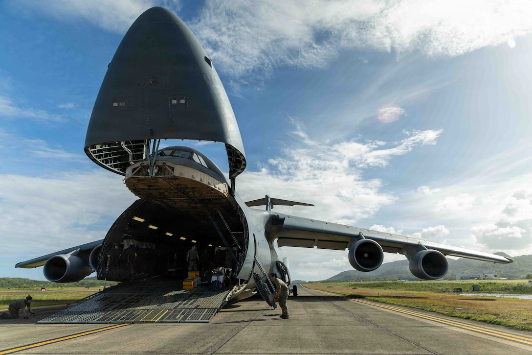 U.S. Airmen assigned to the 9th Airlift Squadron prepare to unload quadruple containers off a C-5M Super Galaxy at U.S. Roosevelt Roads Naval Station, Puerto Rico, May 19, 2026. U.S. military forces are deployed to the U.S. Southern Command area of responsibility in support of Operation SOUTHERN SPEAR, Department of War-directed operations, and the president’s priorities to disrupt illicit drug trafficking, deter malign actors and protect the homeland through continuous presence. (U.S. Marine Corps photo)