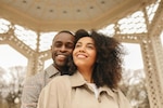 Picture of a man standing behind a woman as they smile