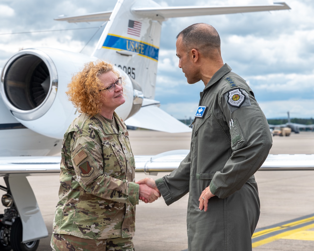 U.S. Air Force Brig. Gen. Adrienne L. Williams, 86th Airlift Wing commander, left, shakes hands with Gen. Adrian Spain, commander of Air Combat Command, at Ramstein Air Base, Germany, May 19, 2026. The visit provided an opportunity for senior leaders to engage directly with Airmen and gain firsthand insight into missions supporting operations and intelligence integration across the European theater. (U.S. Air Force photo by Senior Airman Jared Lovett)