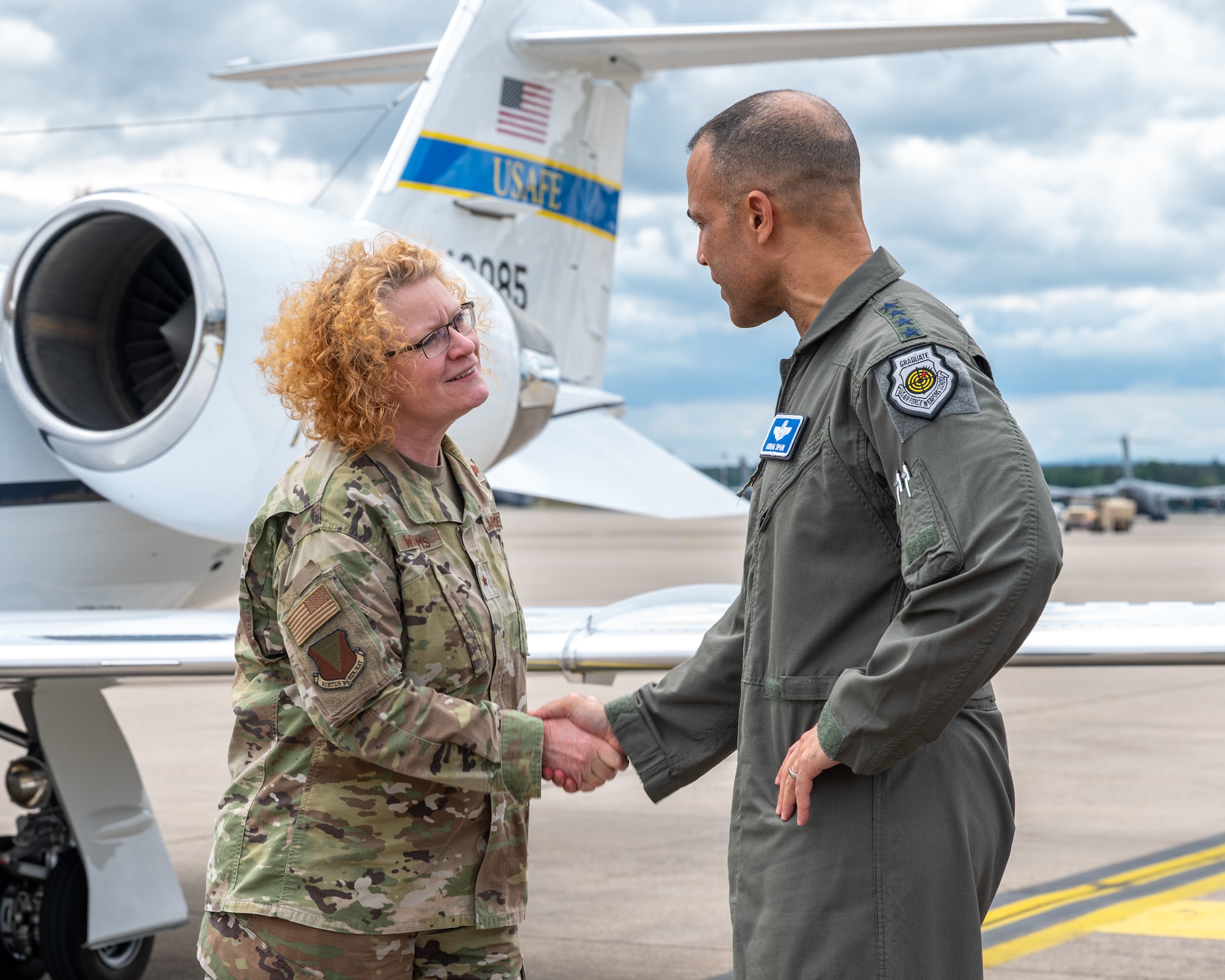 U.S. Air Force Brig. Gen. Adrienne L. Williams, 86th Airlift Wing commander, left, shakes hands with Gen. Adrian Spain, commander of Air Combat Command, at Ramstein Air Base, Germany, May 19, 2026. The visit provided an opportunity for senior leaders to engage directly with Airmen and gain firsthand insight into missions supporting operations and intelligence integration across the European theater. (U.S. Air Force photo by Senior Airman Jared Lovett)