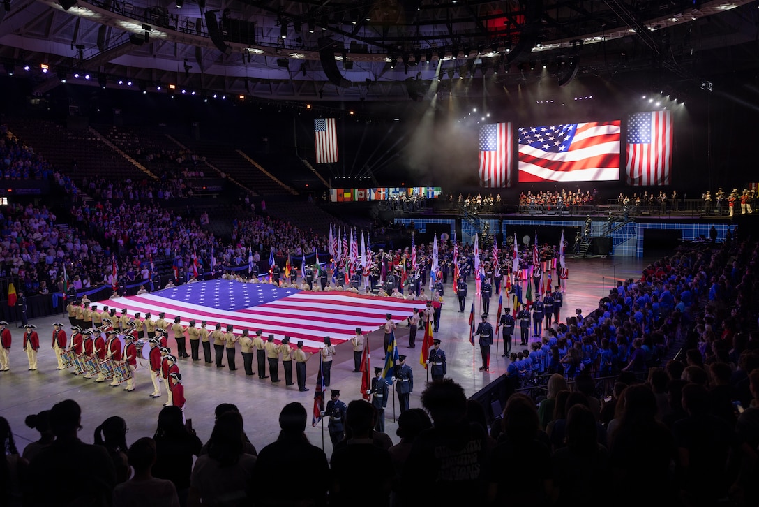 Service members from numerous countries form for the opening performance of the Virginia International Tattoo in Norfolk, Virginia, April 16, 2026. The Virginia International Tattoo is an annual event consisting of performances from military bands, drill teams, dancers and singers from around the world. The event celebrated the alliances between the U.S., the U.K., Canada, France, and South Korea. (U.S. Marine Corps photo by Lance Cpl. Zoey Williams)