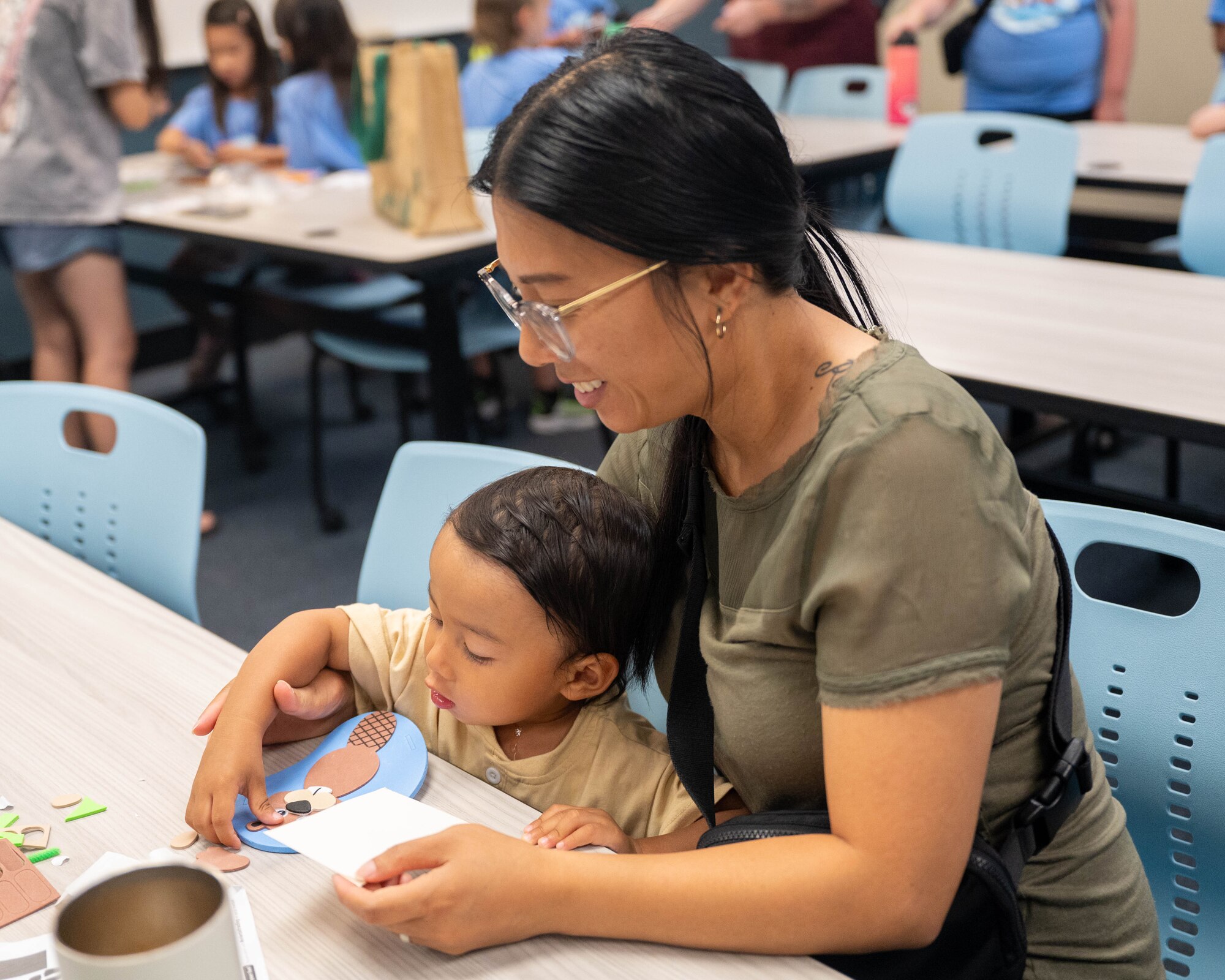 A military family participates in an arts and crafts activity during the 56th Force Support Squadron’s Luke Air Force Base Library "Plant a Seed, Read" summer reading program kickoff at Luke Air Force Base, Arizona, June 3, 2026.