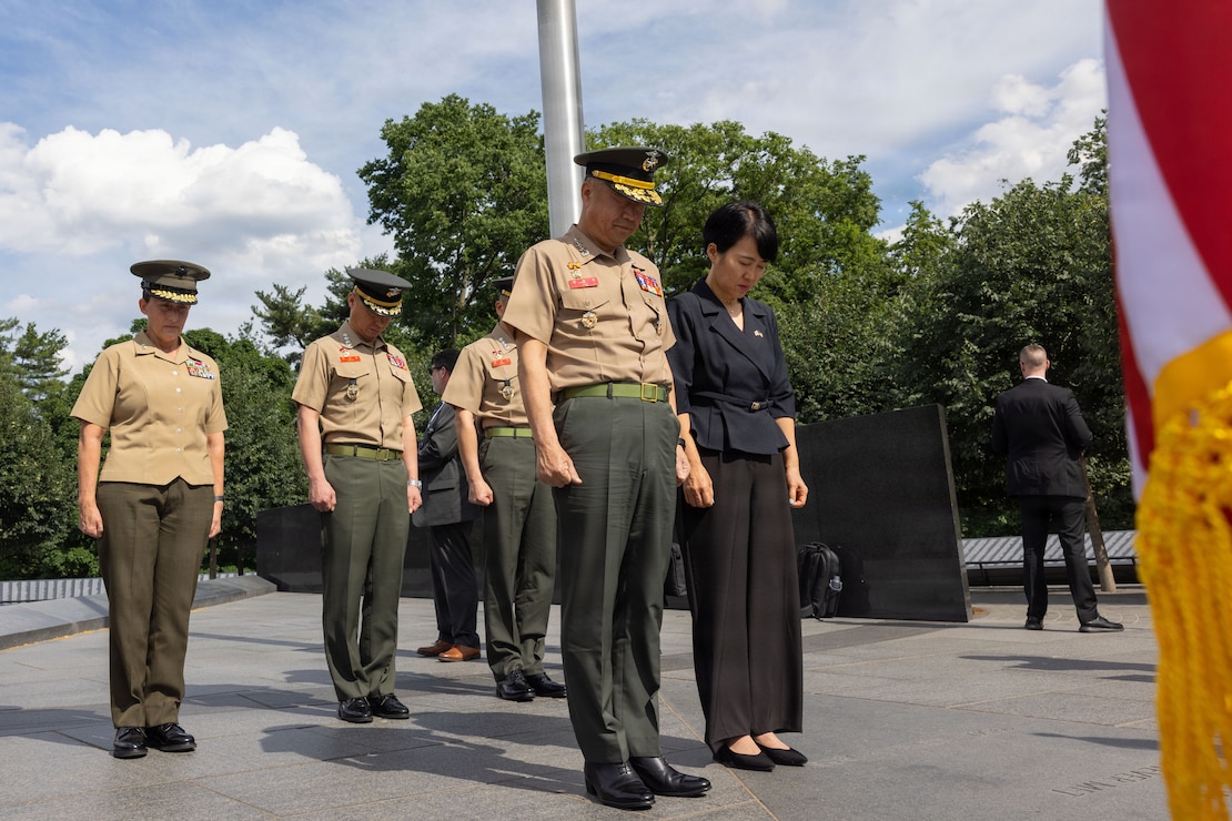 U.S. Marine Corps Maj. Gen. Valerie A. Jackson, commander of U.S. Marine Corps Forces Korea, left, The Commandant of the Republic of Korea Marine Corps, Lt. Gen. Ju Il-seok, right, and Republic of Korea Marines, bow their heads at the Korean War Veterans Memorial wreath-laying ceremony in Washington, D.C