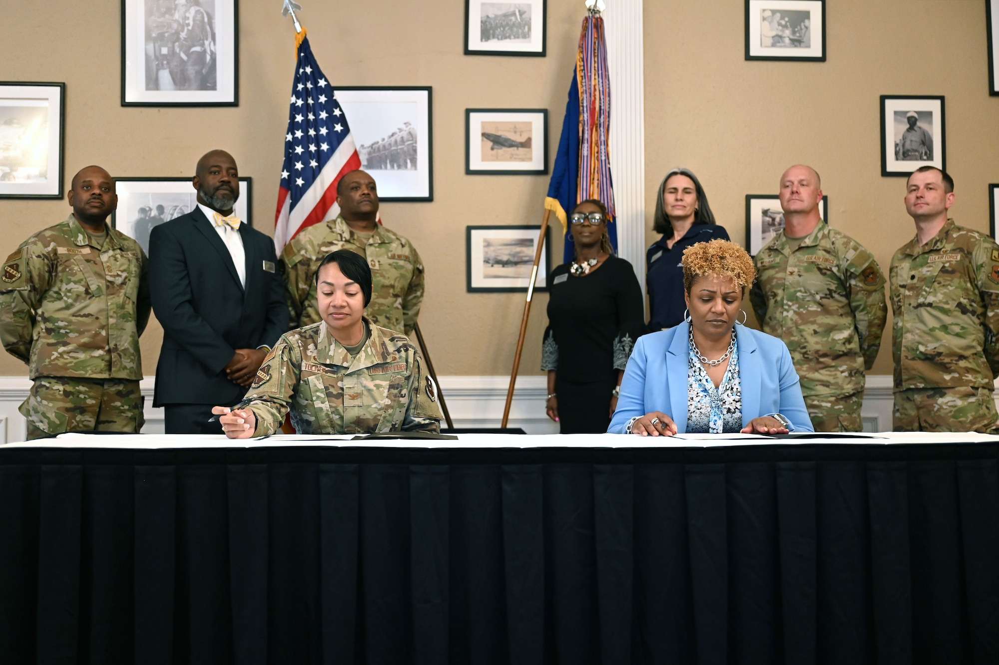 U.S. Air Force Col. Shamekia Toliver, 42d Air Base Wing commander, and Dr. Kemba Chambers, president of Trenholm State Community College, prepare to sign an Intergovernmental Support Agreement at the Maxwell Event Center on Maxwell Air Force Base, Alabama, June 3, 2026. This collaboration creates a potential pipeline of talented childcare professionals for Maxwell and Gunter’s programs. (U.S. Air Force Photo by Eric Sharman)