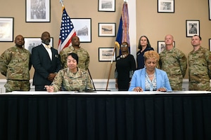 U.S. Air Force Col. Shamekia Toliver, 42d Air Base Wing commander, and Dr. Kemba Chambers, president of Trenholm State Community College, prepare to sign an Intergovernmental Support Agreement at the Maxwell Event Center on Maxwell Air Force Base, Alabama, June 3, 2026. This collaboration creates a potential pipeline of talented childcare professionals for Maxwell and Gunter’s programs. (U.S. Air Force Photo by Eric Sharman)