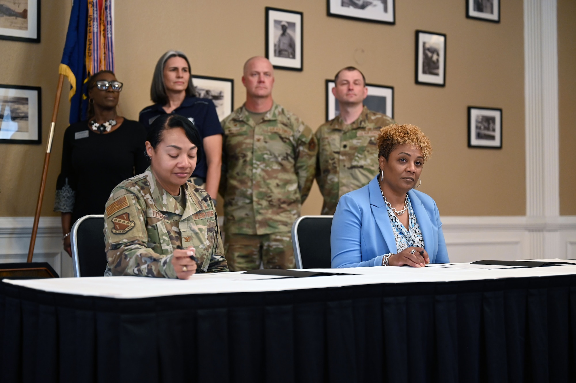 U.S. Air Force Col. Shamekia Toliver, 42d Air Base Wing commander, and Dr. Kemba Chambers, president of Trenholm State Community College, prepare to sign an Intergovernmental Support Agreement at the Maxwell Event Center on Maxwell Air Force Base, Alabama, June 3, 2026. The initiative is part of a broader Air Force effort to leverage community partnerships and serves as a model for military installations nationwide. (U.S. Air Force Photo by Eric Sharman)