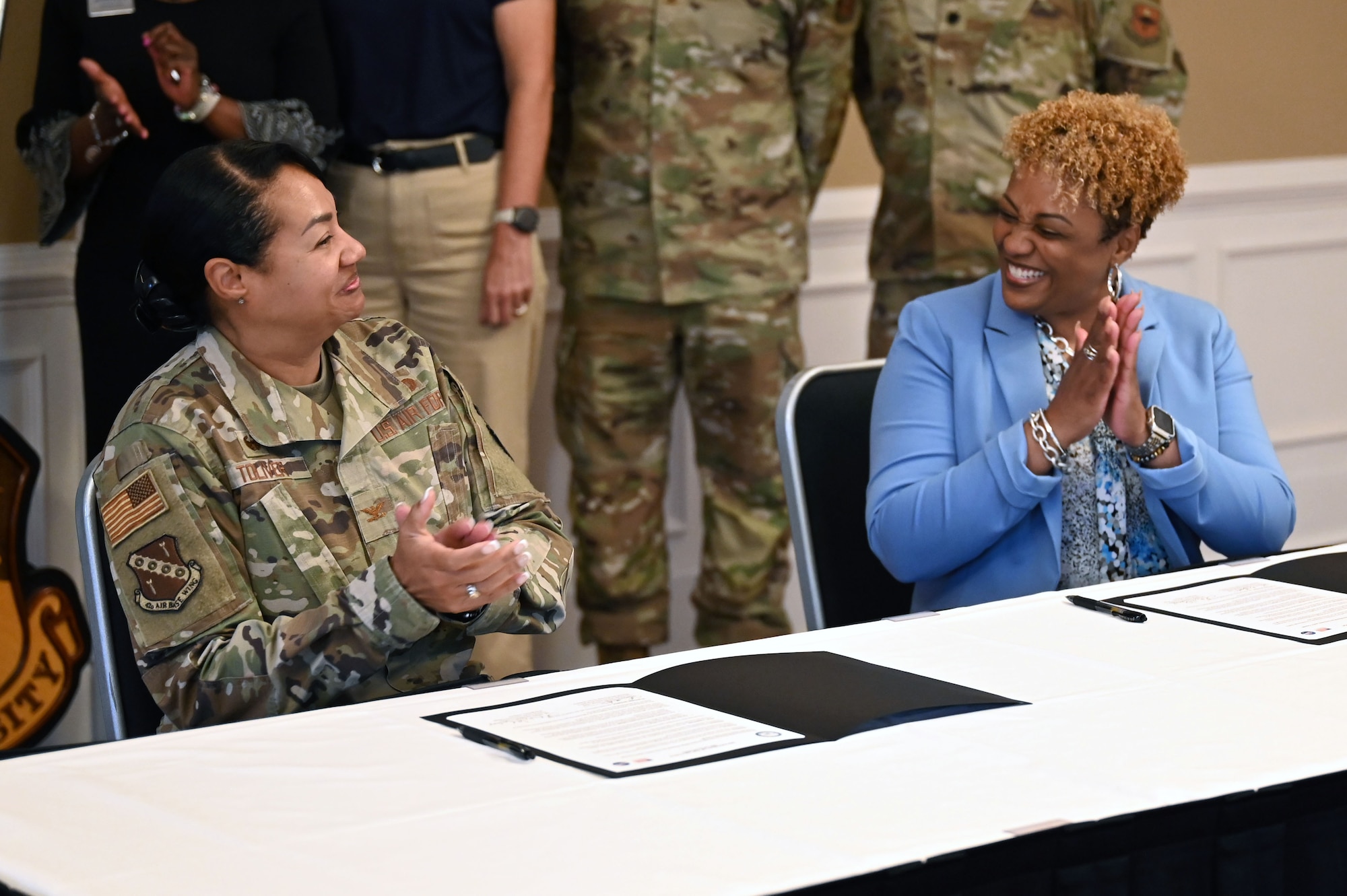 U.S. Air Force Col. Shamekia Toliver, 42d Air Base Wing commander, and Dr. Kemba Chambers, president of Trenholm State Community College, celebrate the signing of an Intergovernmental Support Agreement at the Maxwell Event Center on Maxwell Air Force Base, Alabama, June 3, 2026. The initiative is part of a broader Air Force effort to leverage community partnerships and serves as a model for military installations nationwide. (U.S. Air Force Photo by Eric Sharman)