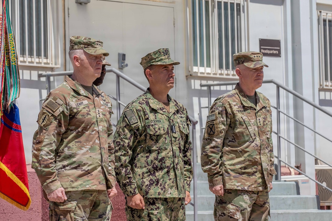 Lt. Gen. Kevin Leahy (left), incoming commander of U.S. Army Central (ARCENT) and Third Army, Adm. Brad Cooper (center), commander of U.S. Central Command, and Lt. Gen. Patrick Frank, outgoing ARCENT commander, prepare to execute the ARCENT change of command ceremony June 4 in the Middle East. (U.S. Army photo)