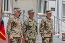 Lt. Gen. Kevin Leahy (left), incoming commander of U.S. Army Central (ARCENT) and Third Army, Adm. Brad Cooper (center), commander of U.S. Central Command, and Lt. Gen. Patrick Frank, outgoing ARCENT commander, prepare to execute the ARCENT change of command ceremony June 4 in the Middle East. (U.S. Army photo)