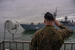 A Polish Army Solider salutes the Finnish Navy's Hämeenmaa-class minelayer FNS Uusimaa (05) as it departs the port of Gdynia, Poland, to participate in exercise Baltic Operations (BALTOPS) 2026 June 4, 2026. BALTOPS 2026, the premiere maritime-focused exercise in the Baltic Region, provides a unique training opportunity to strengthen combined response capabilities critical to preserving freedom of navigation and security in the Baltic Sea. (Polish Navy Photo)