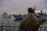 A Polish Army Solider salutes the Finnish Navy's Hämeenmaa-class minelayer FNS Uusimaa (05) as it departs the port of Gdynia, Poland, to participate in exercise Baltic Operations (BALTOPS) 2026 June 4, 2026.