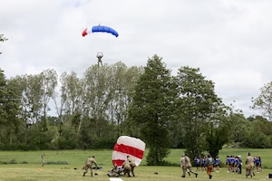 A parachutist delivers the game ball during the Remembrance Bowl in Normandy, France, June 4, 2026. The commemorative football game recognizes the legacy of American airborne forces and pays tribute to those who fought during the D-Day invasion in 1944. (U.S. Army photo by Sgt. 1st Class Christopher Osburn)