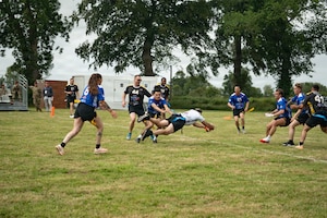 Gen. Christopher Donahue, commanding general of U.S. Army Europe and Africa, dives into the end zone to score a touchdown during the Remembrance Bowl football game in Normandy, France, June 4, 2026. The annual game between the 101st Airborne Division and the 82nd Airborne Division commemorates the service and sacrifice of Allied forces during the D-Day invasion. (U.S. Army photo by Sgt. Noe Cork)