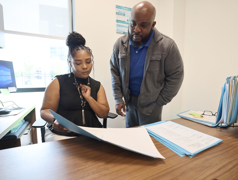 Picture of a man and a woman looking over some papers.