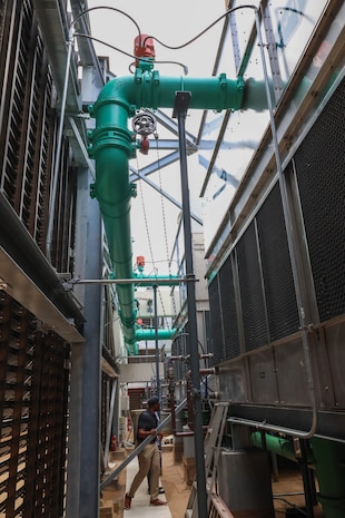 Xavier Thigpen, Huntsville Center project manager, and Jason Bolling, Hale Koa Hotel director of engineering, are photographed inspecting some of the rooftop equpiment.