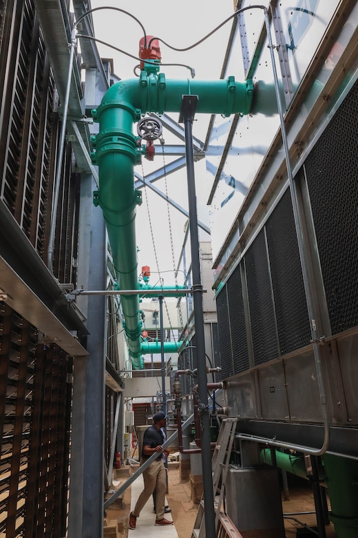 Xavier Thigpen, Huntsville Center project manager, and Jason Bolling, Hale Koa Hotel director of engineering, are photographed inspecting some of the rooftop equpiment.