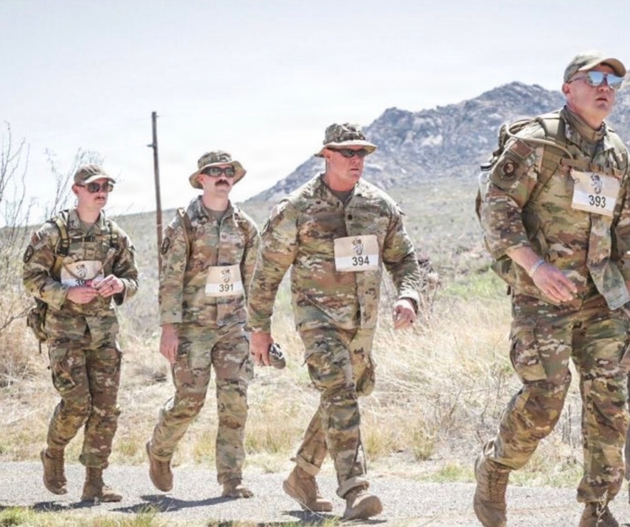 U.S. Air National Guard Airmen assigned to the 184th Logistics Readiness Squadron traverse the high-desert terrain of the White Sands Missile Range, N.M., during the 37th Annual Bataan Memorial Death March, March 21, 2026. The 26.2-mile memorial march honors the sacrifice of American and Filipino service members from World War II. The 184th LRS team participated to build unit cohesion and pay tribute to the resilience of those who defended the Philippine Islands.